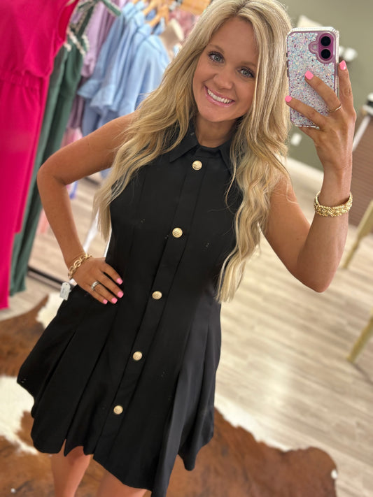 Black sleeveless gold button dress